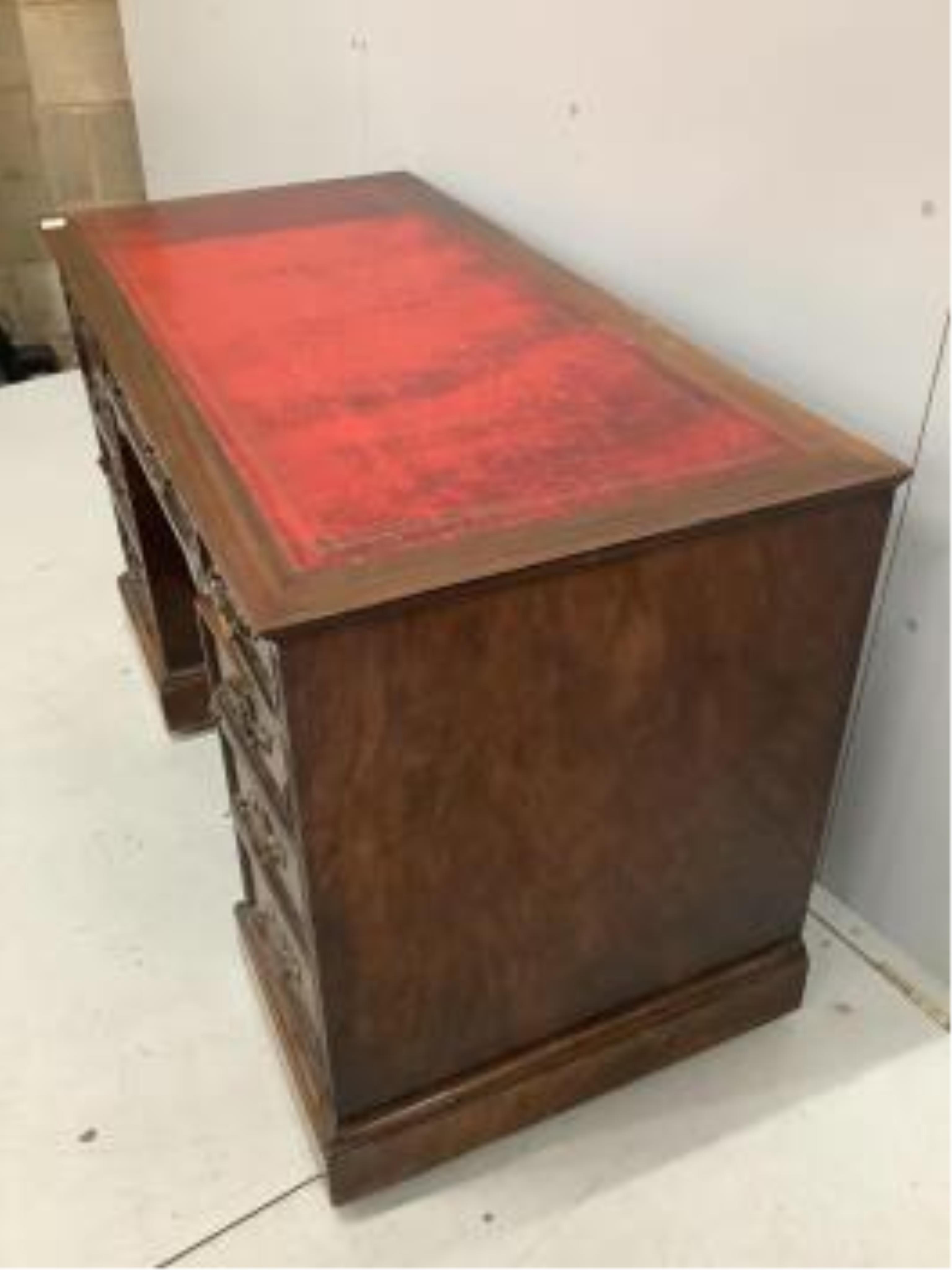 An Edwardian mahogany pedestal desk, pedestals with dummy front drawers, width 121cm, depth 59cm, height 73cm. Condition - fair to good